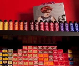 Shelves of professional hair color tubes and bottles