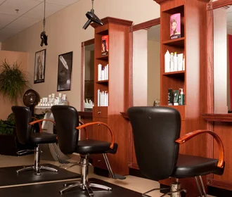 Styling chairs and cherry-wood product shelves inside David Alan Salon
