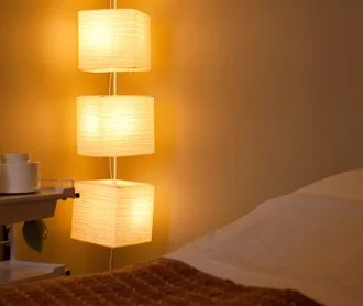 Glowing paper lamps beside a treatment table